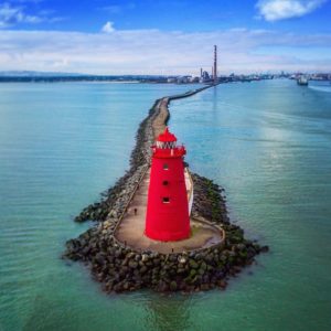 Red lighhouse in the blue sea.