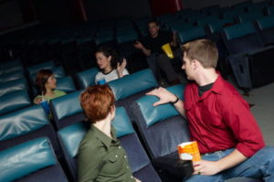 5 friends at theater talking to each others