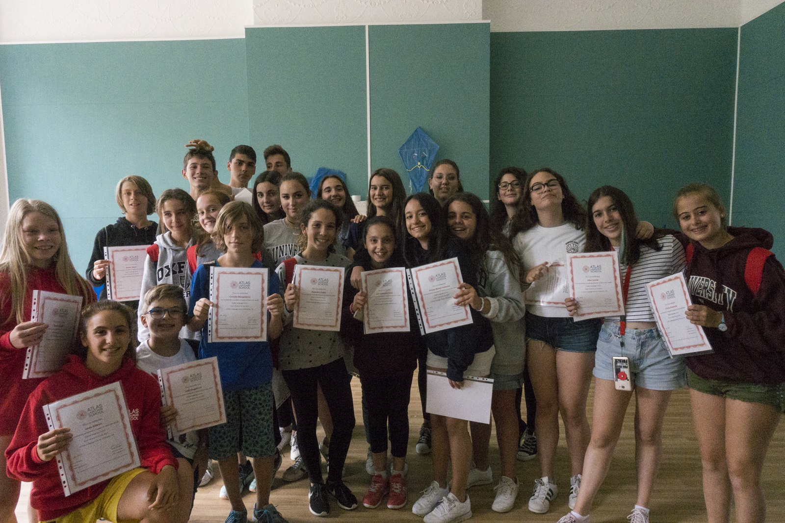 Atlas students with certificates on their last day of school in Chichester