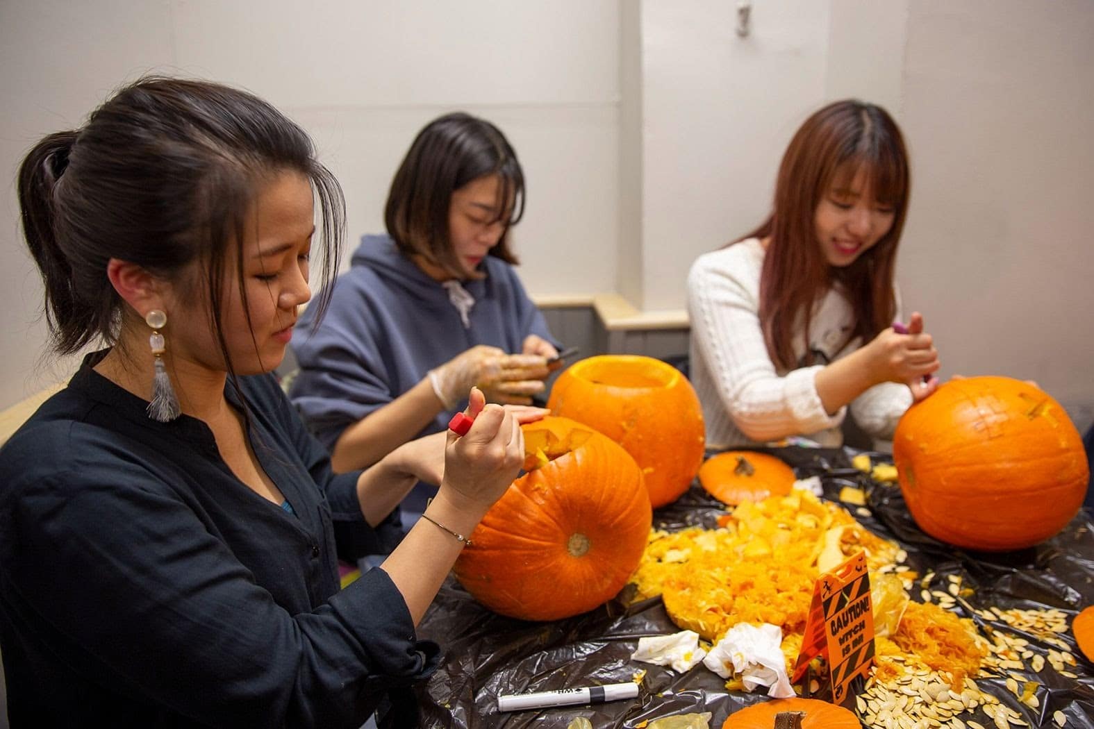 Students carving pumpkins in the school 