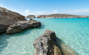 Clear and clean Blue Lagoon in Malta turquoise water and rocks in sunny day
