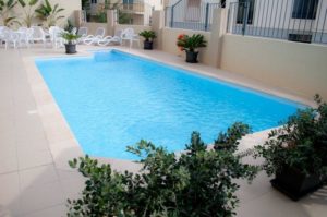 Swimming pool in hotel accommodation that is organised within Atlas Junior Summer Programme Malta