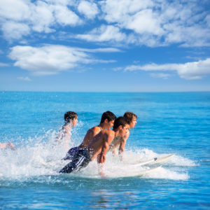 Junior summer programme students in Malta surfing during the summer