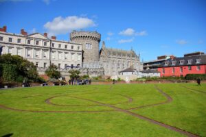 Dublin Castle with its historic architecture and surrounding lush garden, showcasing the blend of heritage and natural beauty.