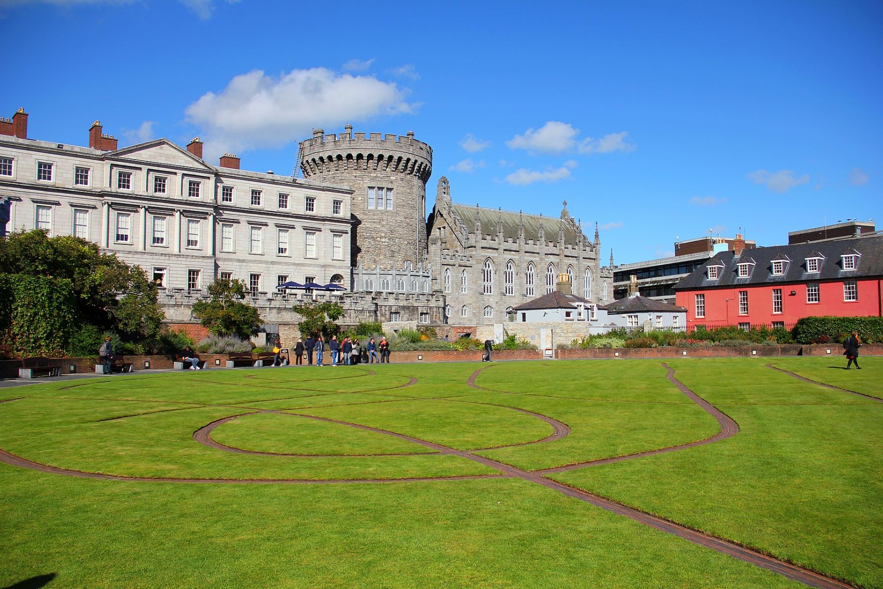 Dublin Castle with its historic architecture and surrounding lush garden, showcasing the blend of heritage and natural beauty.