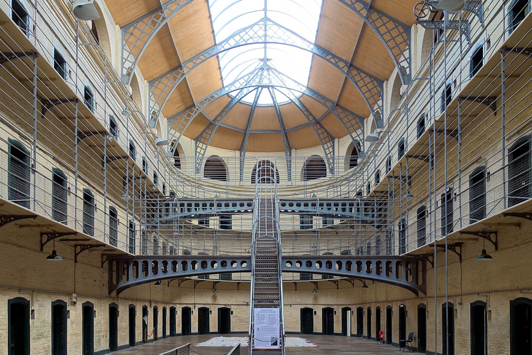 Interior view of Kilmainham Gaol in Dublin, featuring the historic prison cells with their austere, stone walls and barred windows.