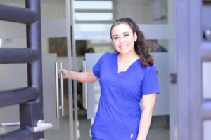 A smiling female medical professional stands confidently, promoting part-time OET exam preparation courses for medical professionals in Dublin.