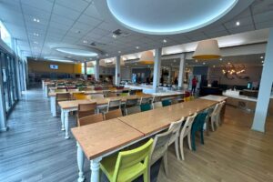 Interior of the Atlas Junior Chichester Canteen, showcasing a modern, vibrant dining space with colorful decor and contemporary furnishings.