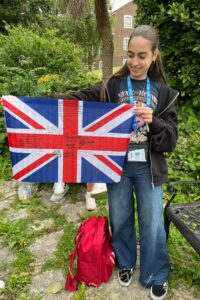 Atlas Junior Chichester student holding the UK flag