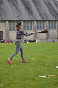 Student playing hurling during Atlas Junior Clare sports activities.