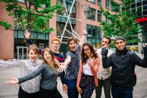 group of English language students enjoying their time in Liverpool, surrounded by the city's iconic landmarks and vibrant atmosphere.