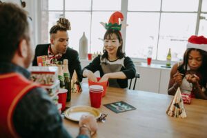 Friends spending time together over Christmas. Dinner party. Games night