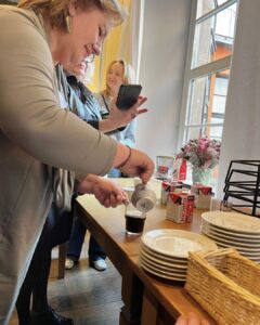 Participant at the Erasmus+ event in Wroclaw pours cream over Irish coffee during the cultural workshop hosted by Atlas Language School.