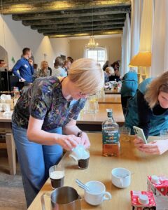 Guests at the Erasmus+ event in Wroclaw enjoy hands-on Irish coffee making, guided by Atlas Language School staff in a lively cultural exchange.
