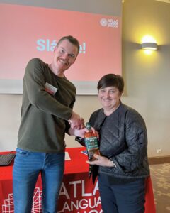 Erasmus+ event attendee receives a bottle of Tullamore D.E.W. Irish whiskey from Ciarán Lynch of Atlas Language School during the prize giveaway.
