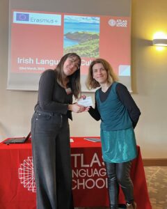 Lucky participant wins a cultural experience voucher at the Erasmus+ event in Wroclaw, handed over by Marine Onno from Atlas Language School.