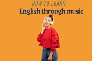 A young woman with dark hair in a bun wears white headphones and a red sweater while listening to music. She gently touches the headphones with one hand and looks relaxed. The background is a solid orange color, and the text on the image reads: 'How to learn English through music.'
