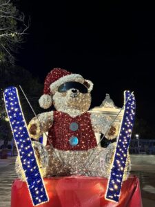 Christmas installation of a teddy bear on skis wearing sunglasses and a Santa hat