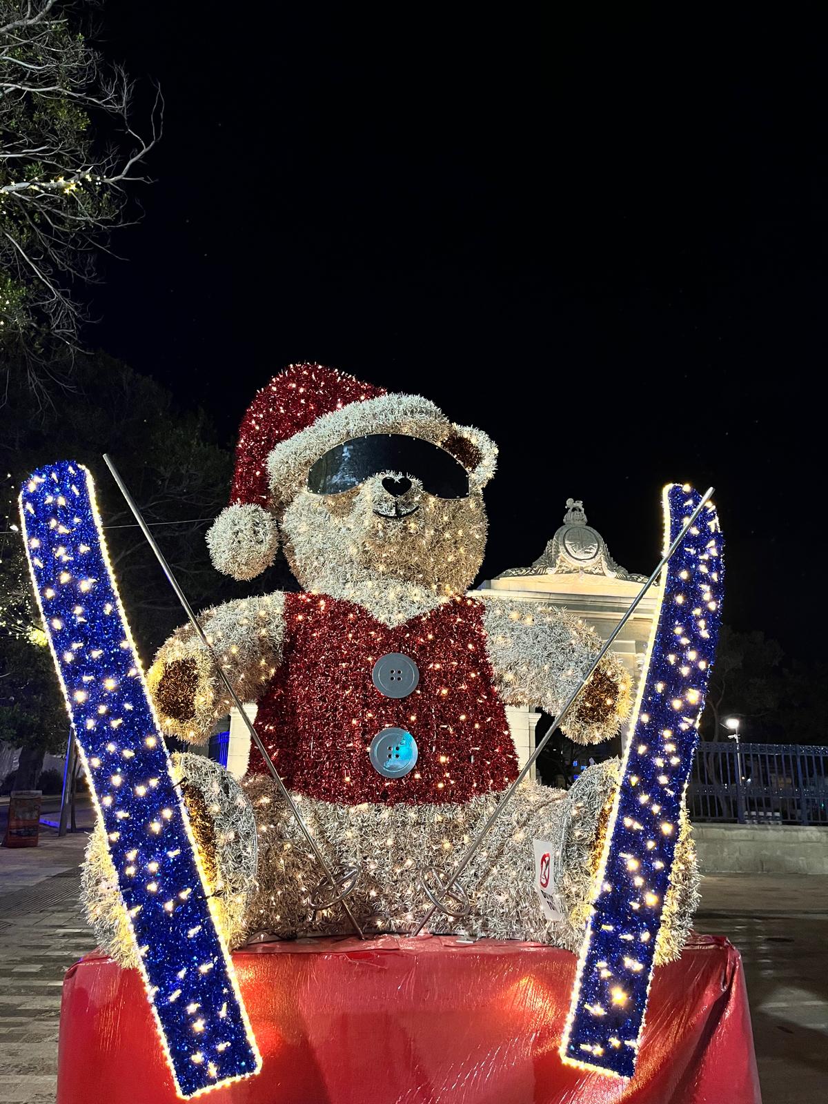 Christmas installation of a teddy bear on skis wearing sunglasses and a Santa hat