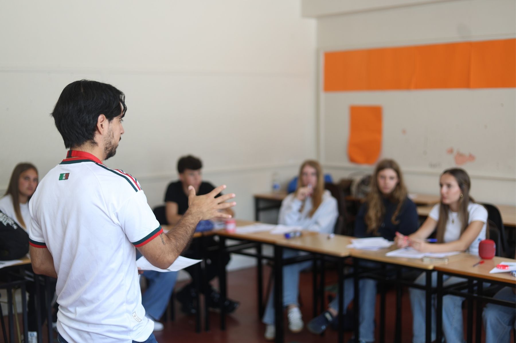 Junior students during English class listening their teacher
